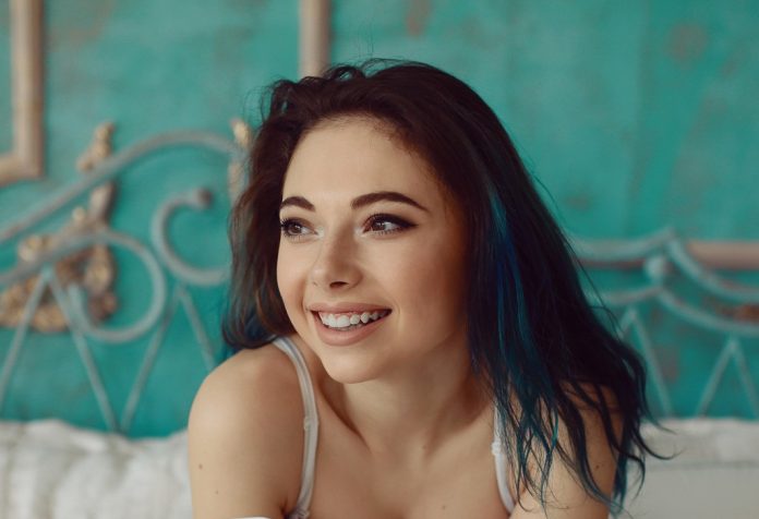 Woman stretching in bed after wake up